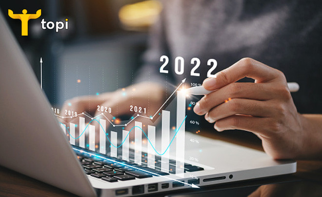 Bàn tay đang điều khiển máy tính bảng hiển thị biểu đồ giao dịch chứng khoán ATO