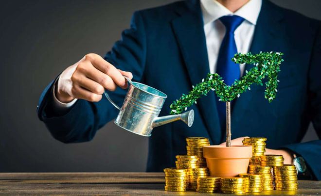 Người đàn ông đang nhìn vào biểu đồ tài chính, tượng trưng cho việc xác định thời điểm đầu tư chứng khoán hiệu quả